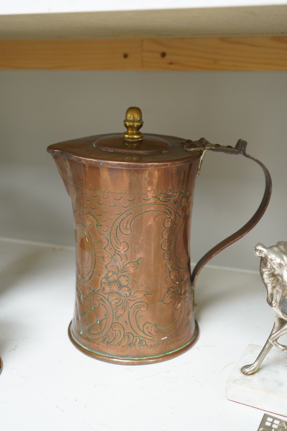 A pair of French Art Deco stag bookends, a chrome Greyhound mounted on a marble base, a large Arts and Crafts copper jug and two other items, jug 27cm high